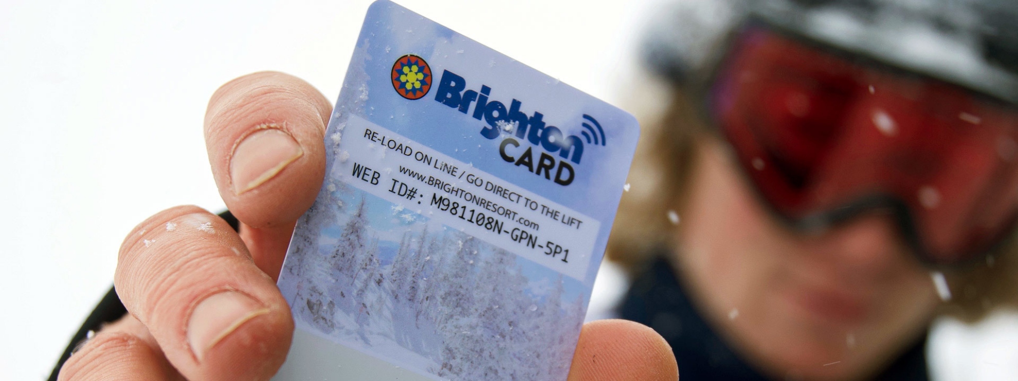 Snowboarder displaying his Brighton Card