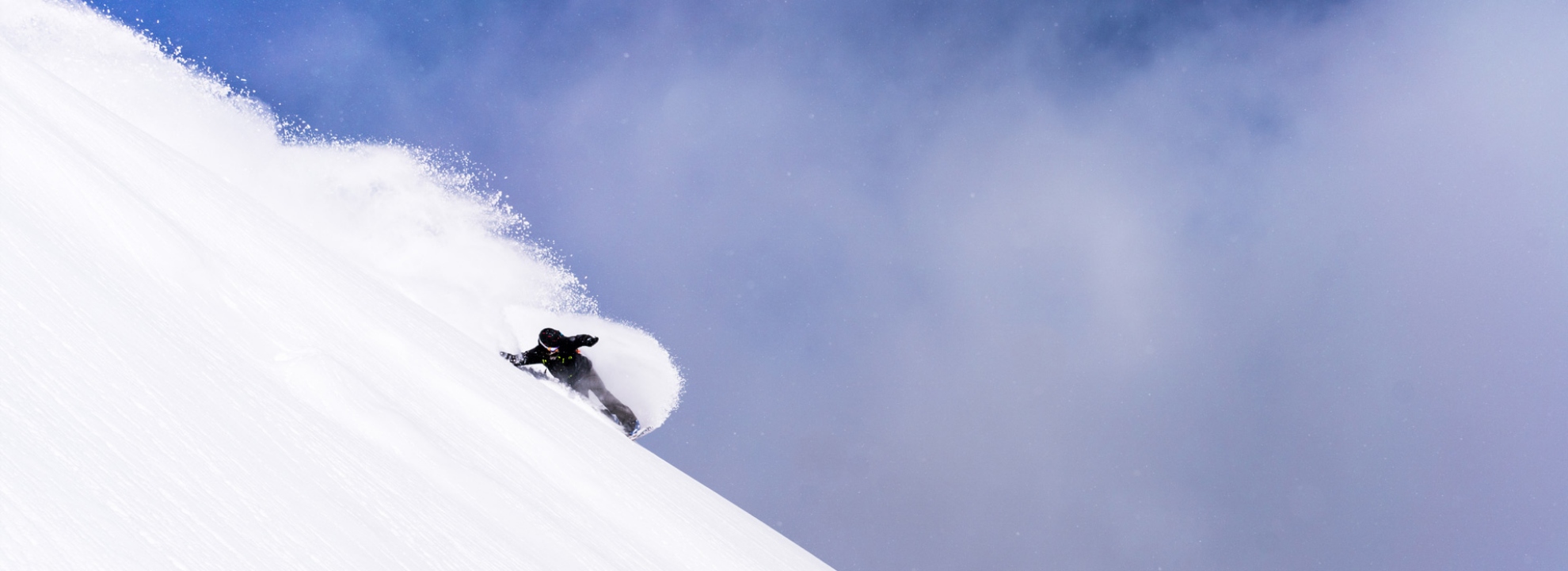 Snowboarder riding deep powder at Brighton Resort
