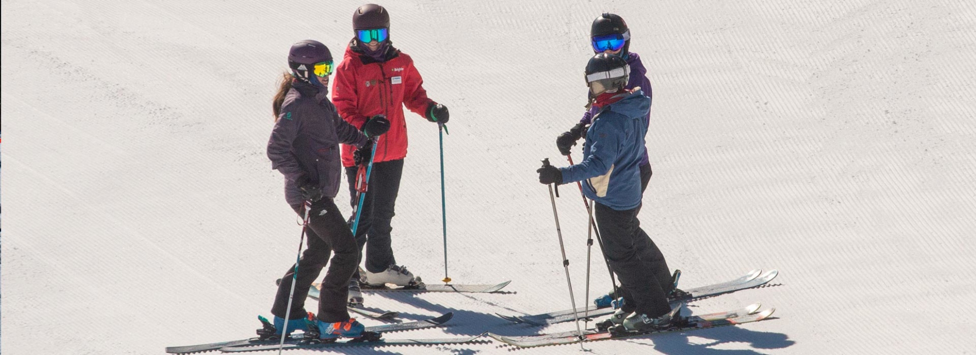 Women learning to ski together with a Brighton Snowsports School instructor	