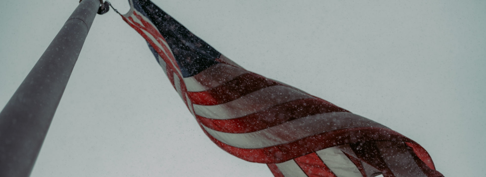 American flag under snowfall
