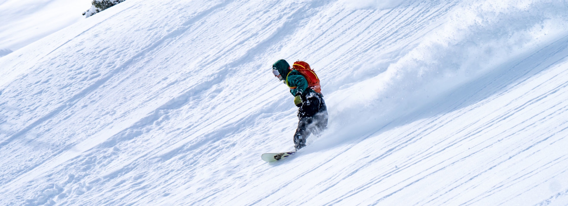 Snowboarder riding deep snow at Brighton Resort	