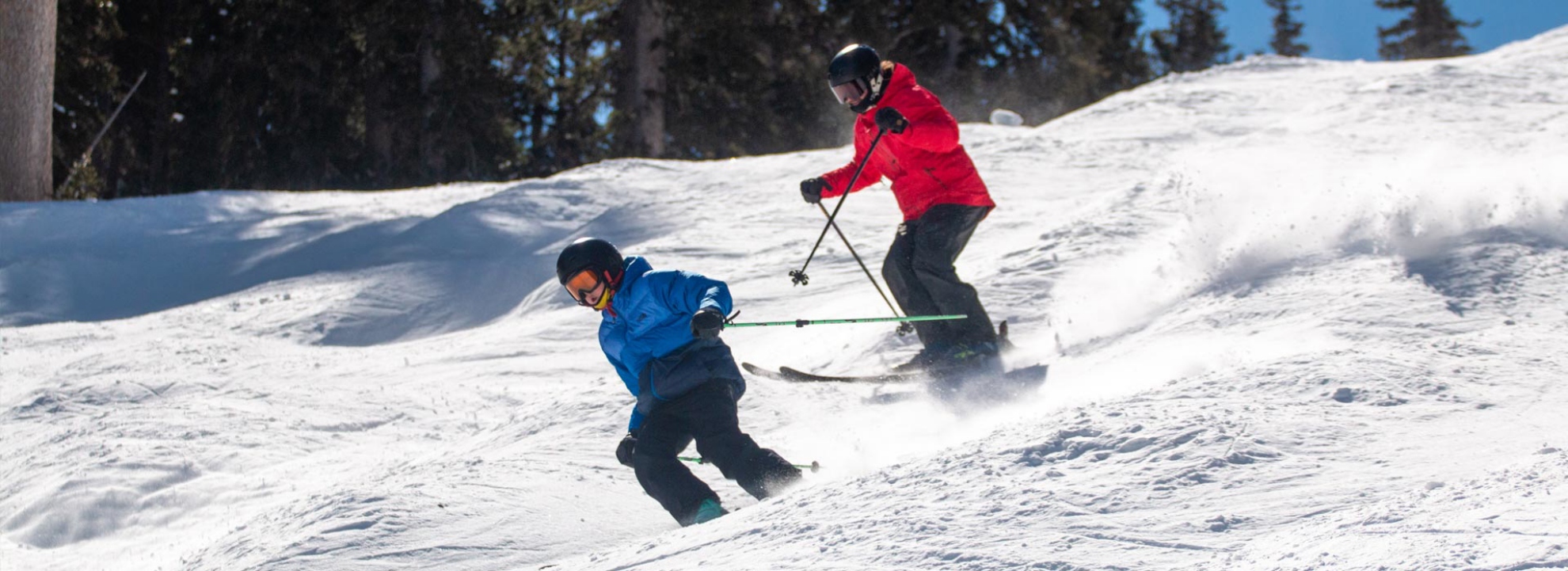 A Brighton Resort instructor teaching a young teen how to ski.	