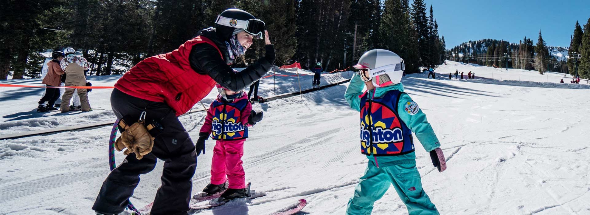 A Brighton Resort instructor teaching a young children how to ski.